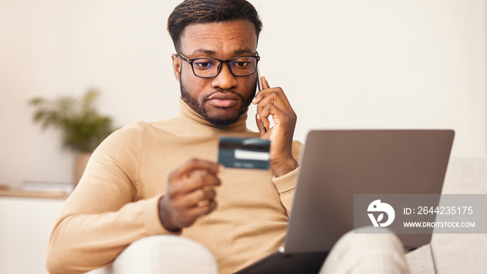 African american man calling to bank shopping online at home