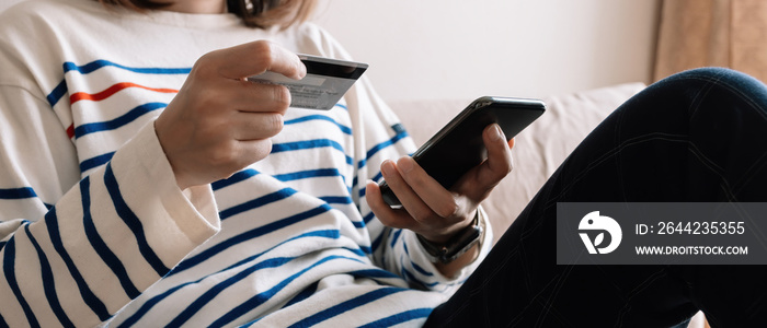 Online shopping payment,Womans hands holding a smart phone and credit card and for online shopping 