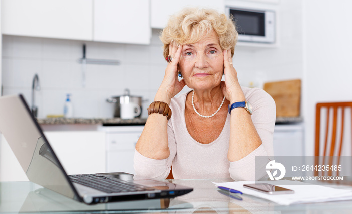 Confused woman using laptop