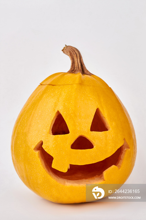 Funny face of Halloween pumpkin. Head of lantern carved from pumpkin. Isolated on white background.