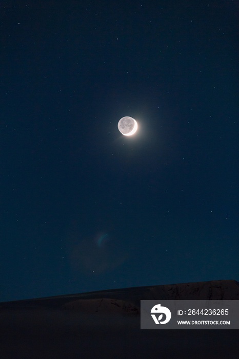 The full moon in the sky full of stars at night time