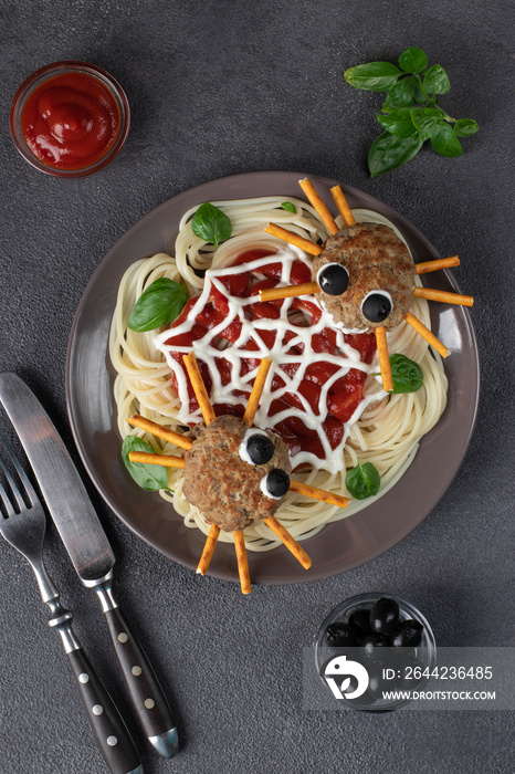 Cutlets look like spiders with olives and straws, served with spaghetti pasta and tomato sauce. Hall