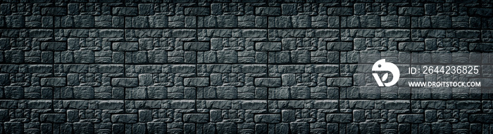 Black patterned tile wall wide texture. Dark masonry long backdrop. Gloomy gothic background