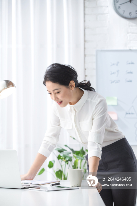 青年商务女人使用笔记本电脑办公