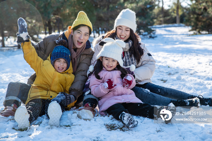 快乐的一家人坐在雪地上