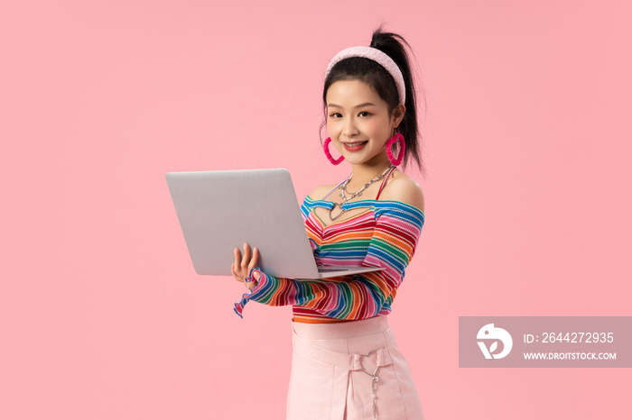 使用笔记本电脑的时尚年轻女孩