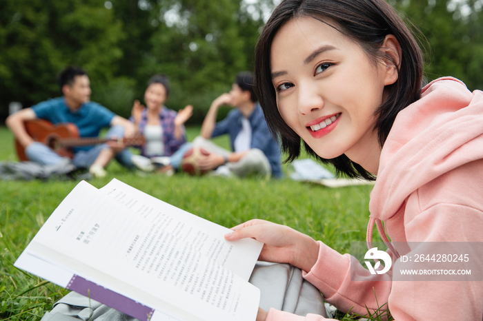 大学生在草地上享受课余时间