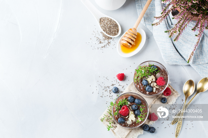 Healthy vegan chocolate chia pudding with berries and green thyme