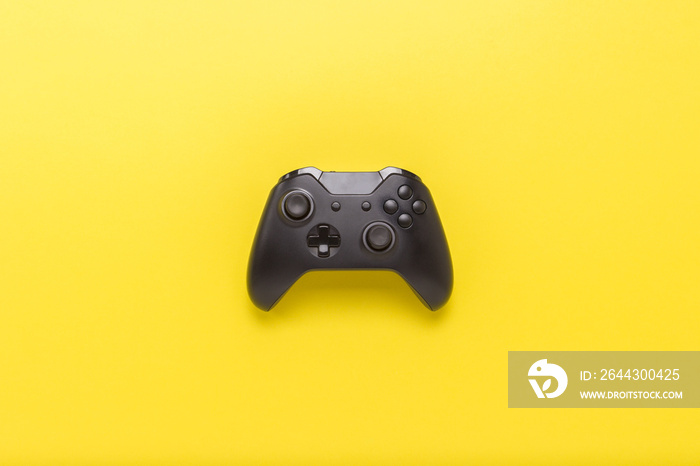 Gamepad on a yellow background. Concept of the game in the console or computer. Rest after work. Cybersport. Flat lay, top view