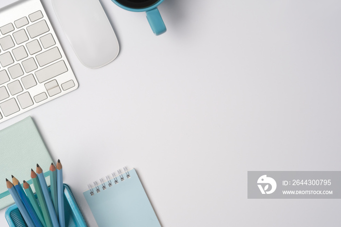 Top view copy space with coffee cup, wireless mouse, pencil holder, keyboard, and notepad.