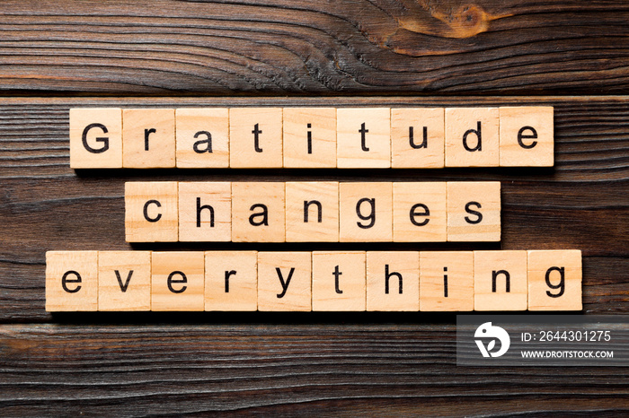 Gratitude changes everything word written on wood block. Gratitude changes everything text on wooden table for your desing, concept