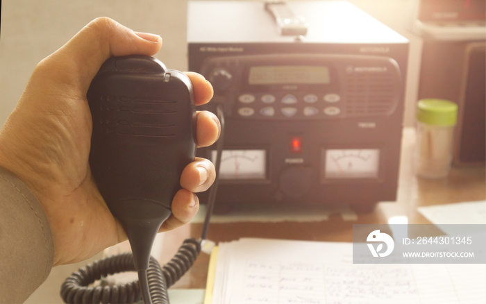 Police in the operation room use two-way radios to communicate and coordinate responses to emergency situations, providing essential real-time information.