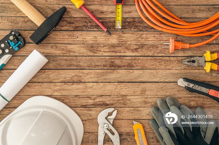 Flat lay composition with different construction tools on wooden background.