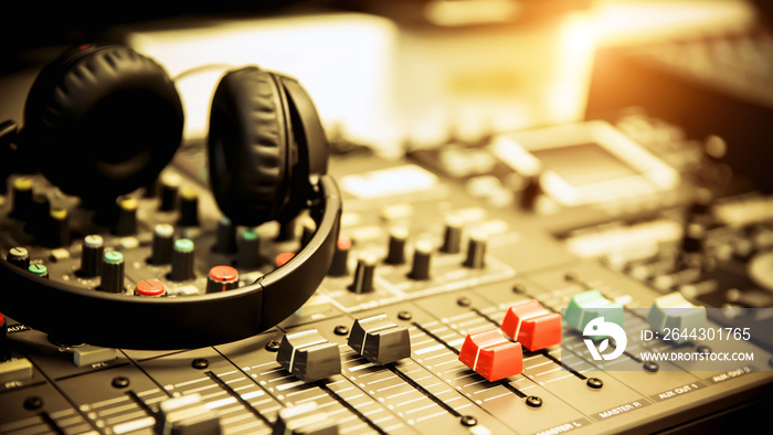 Close-up headphone and audio mixer in studio concepts room for sound control and recording equipment and music instrument