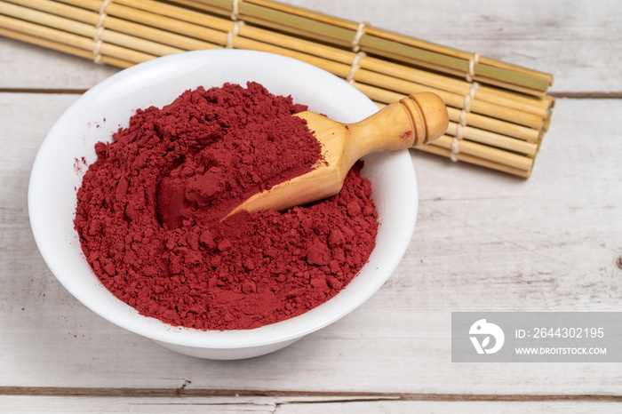 Red yeast rice powder or angkak. Chinese natural coloring and spice for cooking and food.
