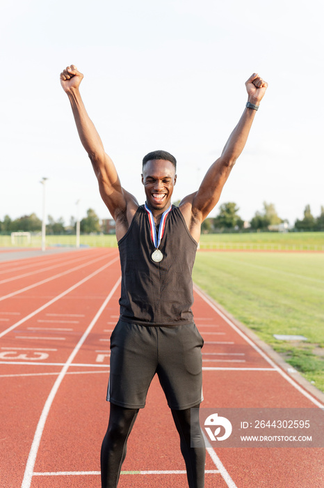 Portrait of athlete celebrating with medal