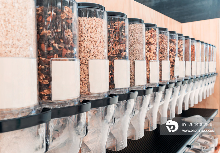 bulk food dispensers display with grains in a store close up