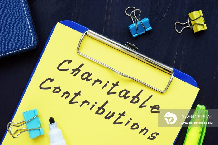 Business concept about Charitable Contributions with sign on the page.