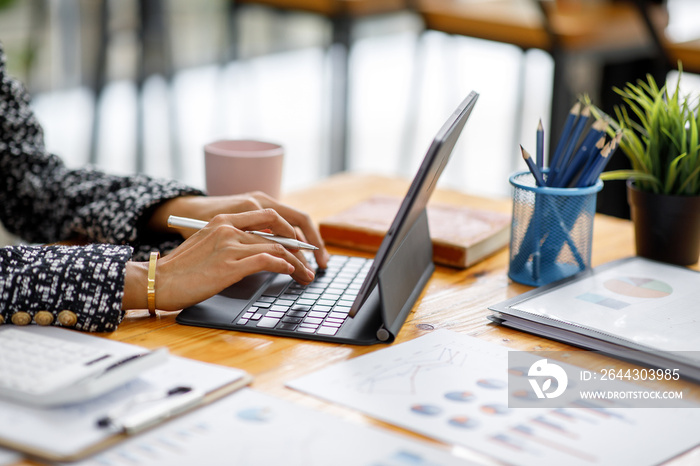 Businesswoman working at office with documents on his desk, doing planning analyzing the financial report, business plan investment, finance analysis concept