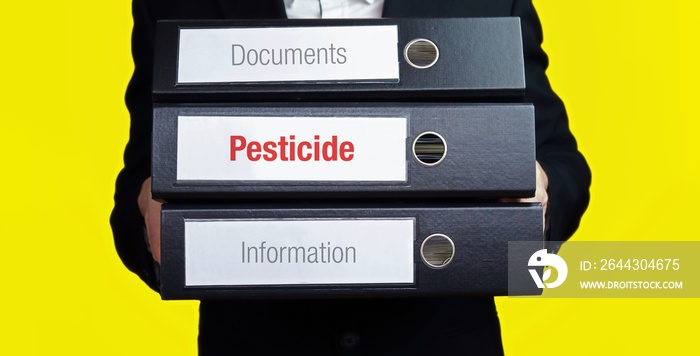 Pesticide – finance/economics. Man carries a stack of 3 file folders. A folder has the label Pesticide. Business, statistics concept