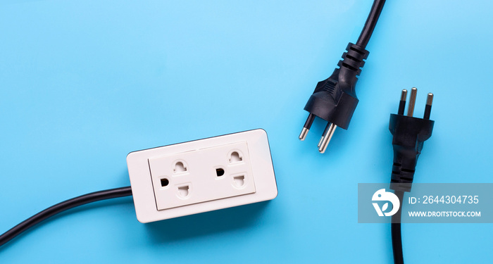 Electrical power strip and plug on blue background.