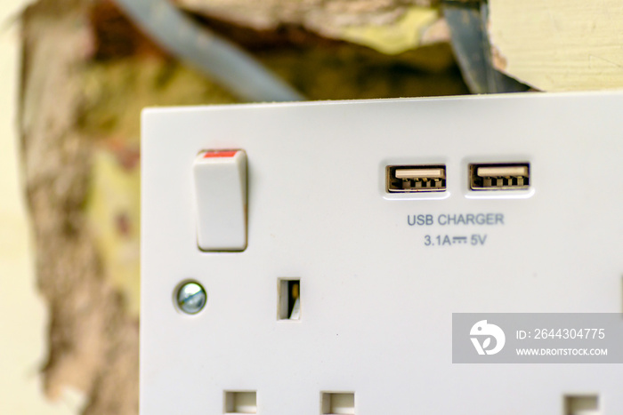 electric socket in a wall during renovation in england uk