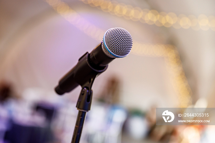 Microphone on stage against a background of the hall.