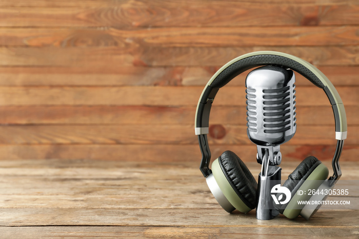 Headphones with microphone on wooden background