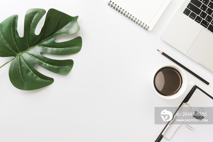 Flay lay, Top view office table desk with smartphone, keyboard, coffee, pencil, leaves with copy space background.