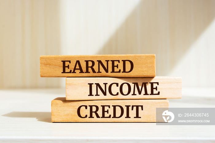 Wooden blocks with words ’EARNED INCOME CREDIT’. Business concept