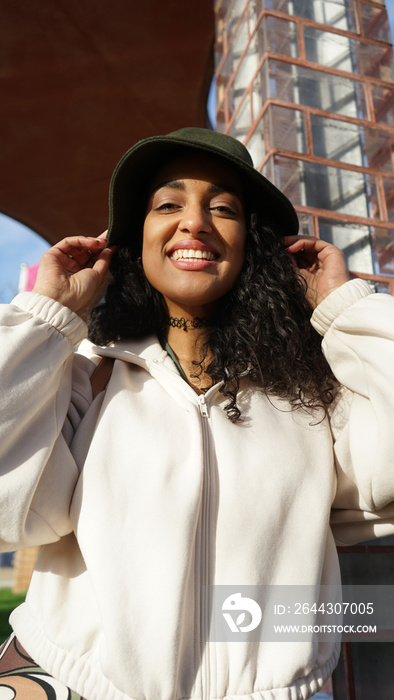 Portrait of smiling woman in hat outdoors