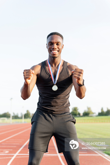 Portrait of athlete celebrating with medal