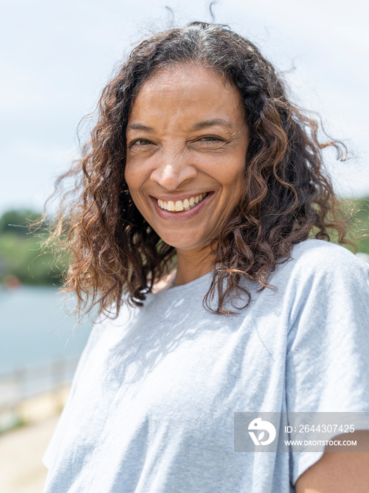 Portrait of smiling woman by lake