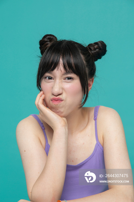 Studio portrait of girl grimacing