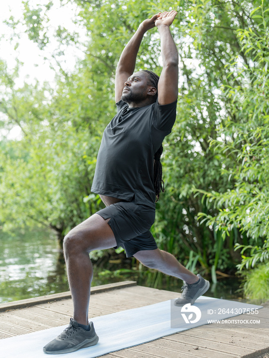 Man practicing yoga in park