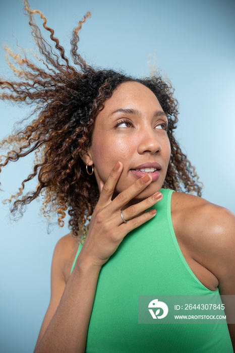 Portrait of woman with curly hair and green top