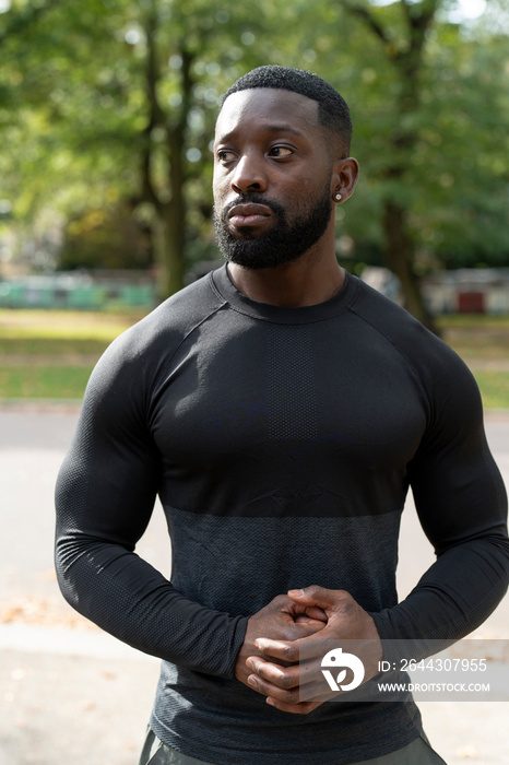 Portrait of athletic man standing in park