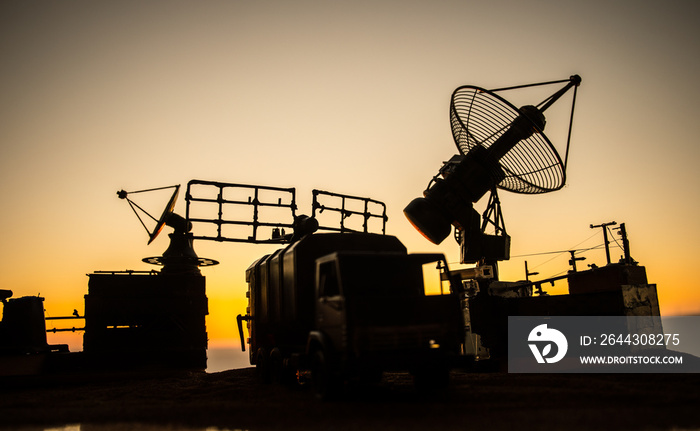 Satellite dishes or radio antennas against evening sky. Selective focus