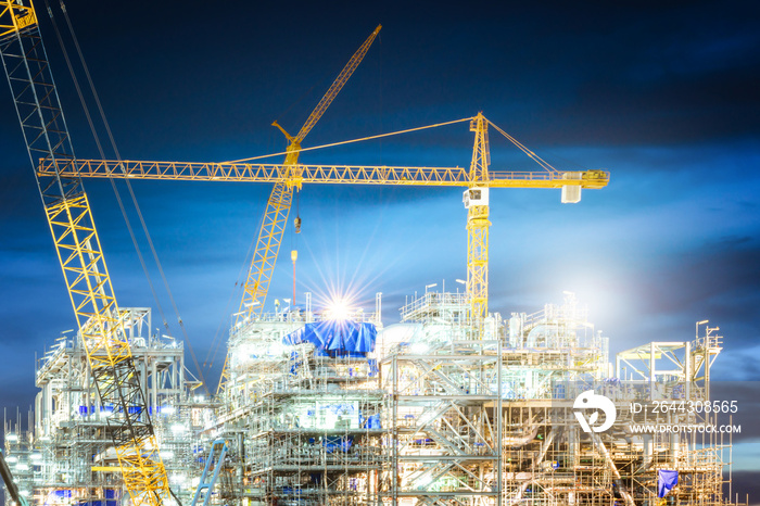 Construction of oil and gas refinery at twilight sky