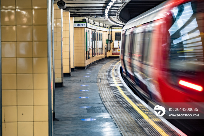 Motion blurred underground train with empty platform