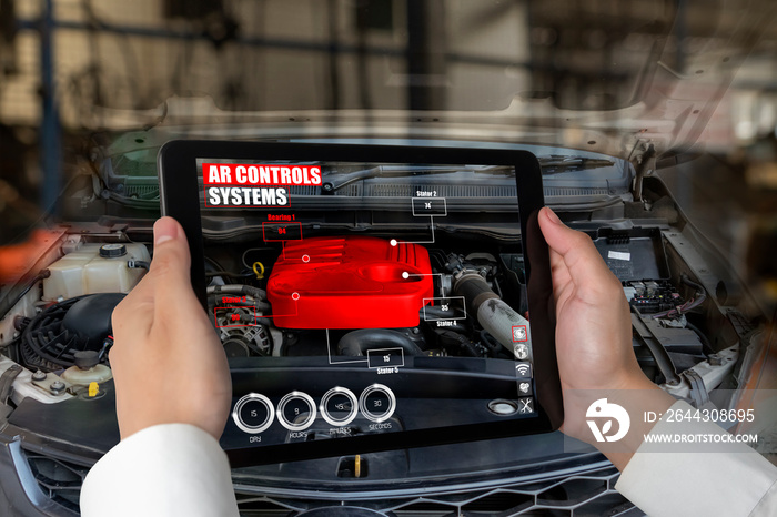 Engineer use augmented reality software to monitor parts of car vehicle with automated application . Futuristic machinery in working in concept of Industry 4.0 or 4th industrial revolution.