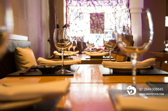 Elegant restaurant table with cutlery, crockery and glasses.