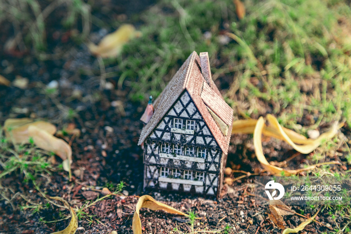 a small model of a half timber house on the ground