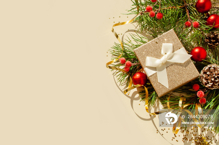 Gold boxes with a gift and Christmas tree branches on a white background. View from above