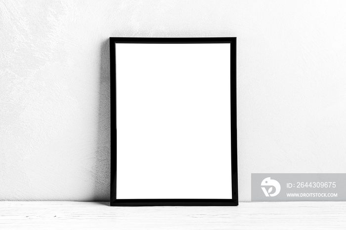 White wooden floor over concrete or decorative plaster wall and black photo frame with copy space for a text background. Mock up.