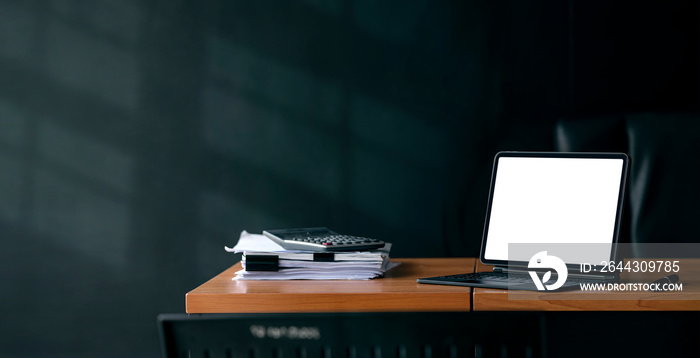 Workspace, mockup open blank screen digital tablet with magic keyboard on wooden desk in dark tone office room, banner.