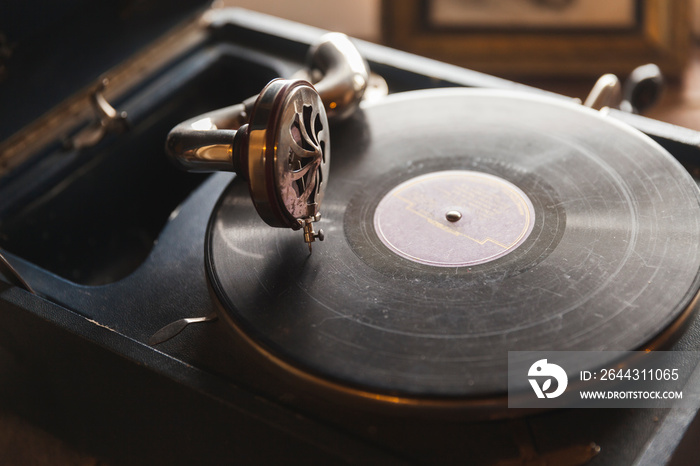 Vintage phonograph with black vinyl record