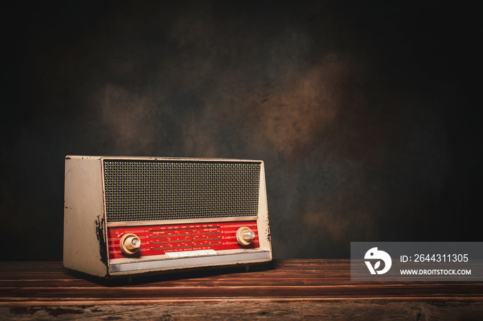 Antique, Retro old radio on wooden table in front of wall background with copy space on the right