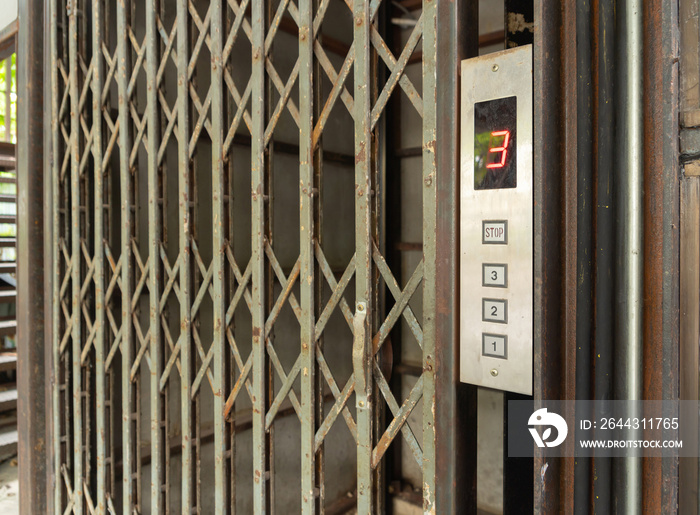 A classic old elevator lift with collapsible gate in hotel. Interior architectural element. Antique and vintage design.