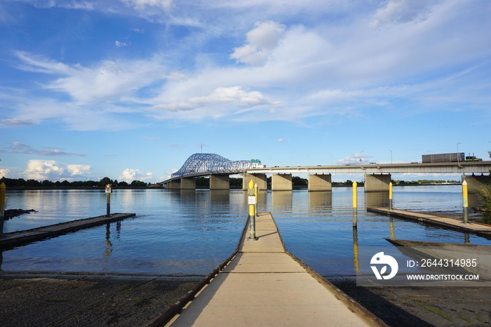 boat launch and dock with bridge in background